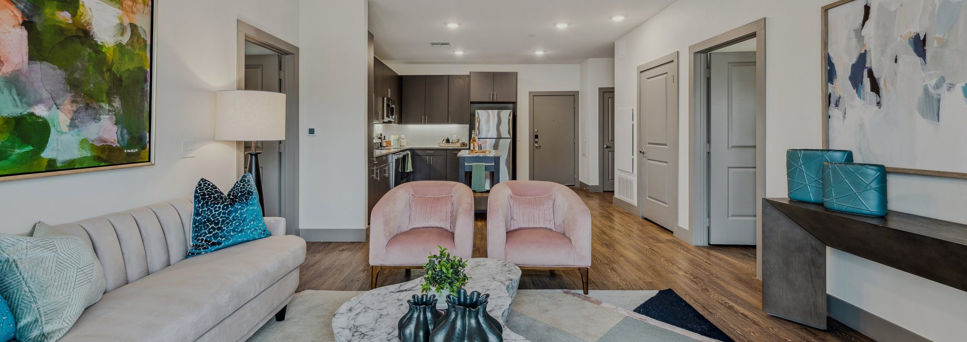 the living room has a couch, coffee table and chairs at The BroadVue