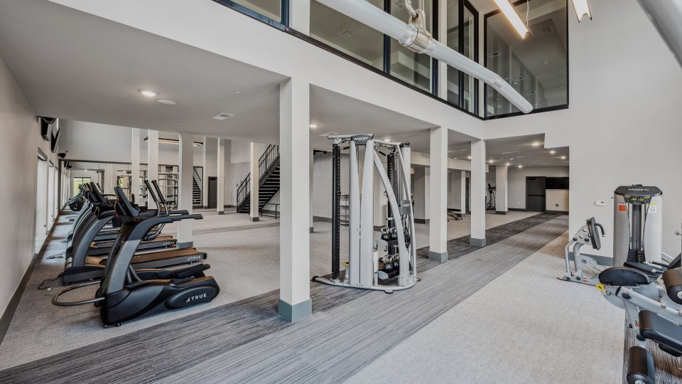 a gym with treadmills and exercise equipment at The BroadVue